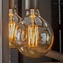 Lichtbron bol Ø12,5 cm LED filament goldline - E27 6W 2100K 450lm dimbaar / Amberkleurig glas