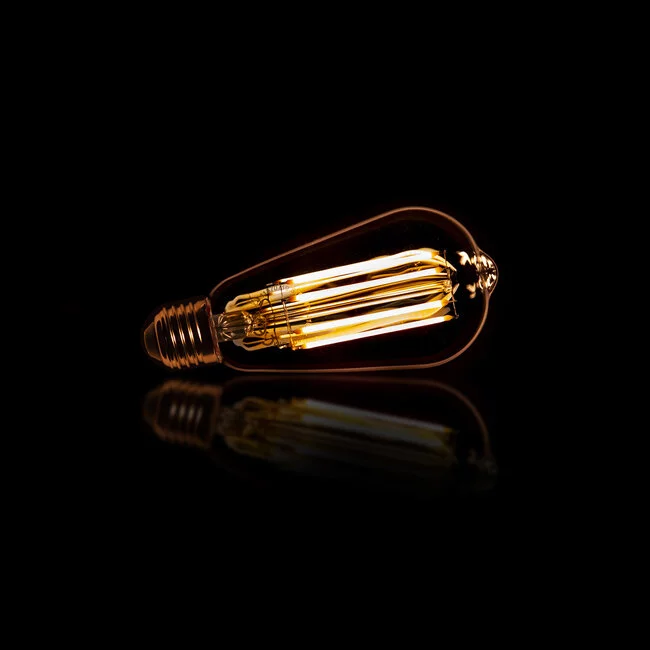 WoonStijl Lichtbron LED filament druppel - E27 6W 2100K 450lm dimbaar / Amberkleurig glas